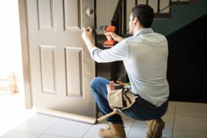 The man installing the door lock in home at Vancouver, BC