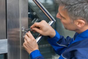 A locksmith is trying to unlock a door using special equipment in the Vancouver Metro Area
