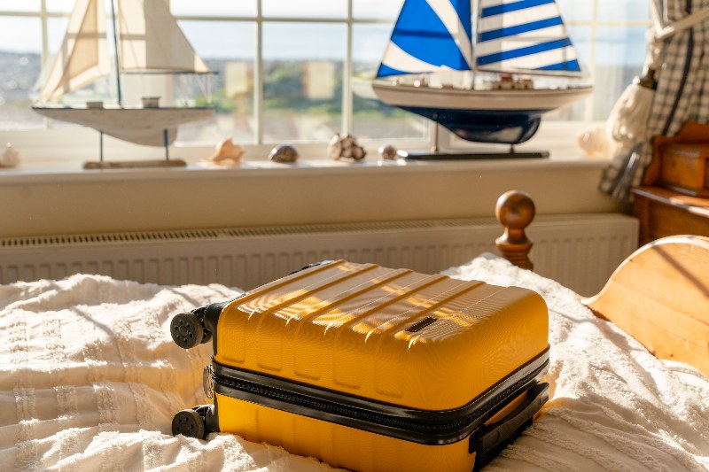 Suitcase or luggage bag in a classic old hotel room with sea view in Vancouver, BC